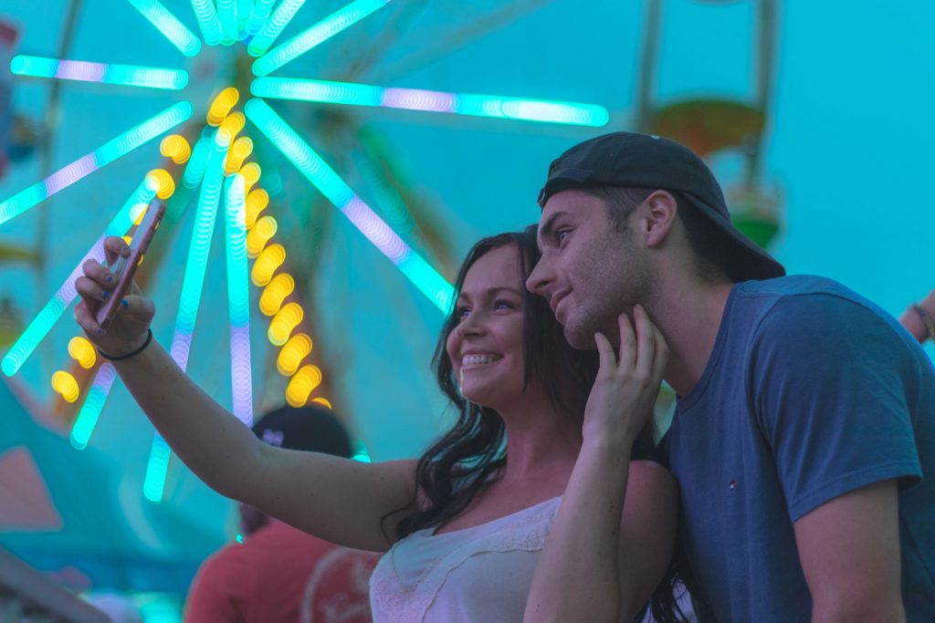 man and woman taking selfie photography