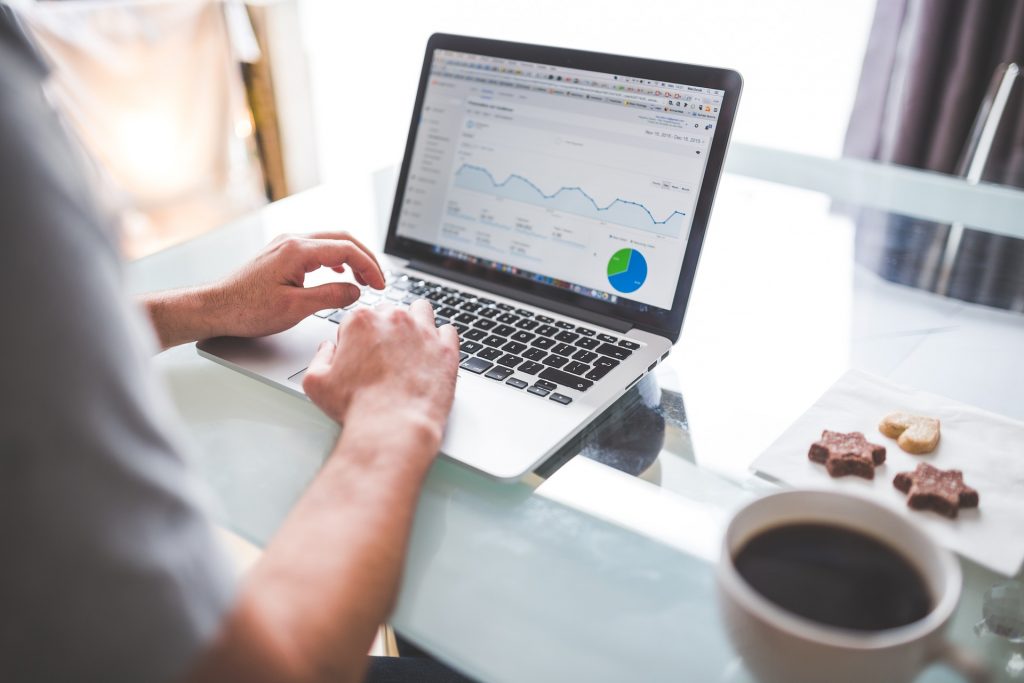 Person using laptop with Google Analytics on display