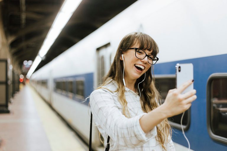 Woman with phone and headphones