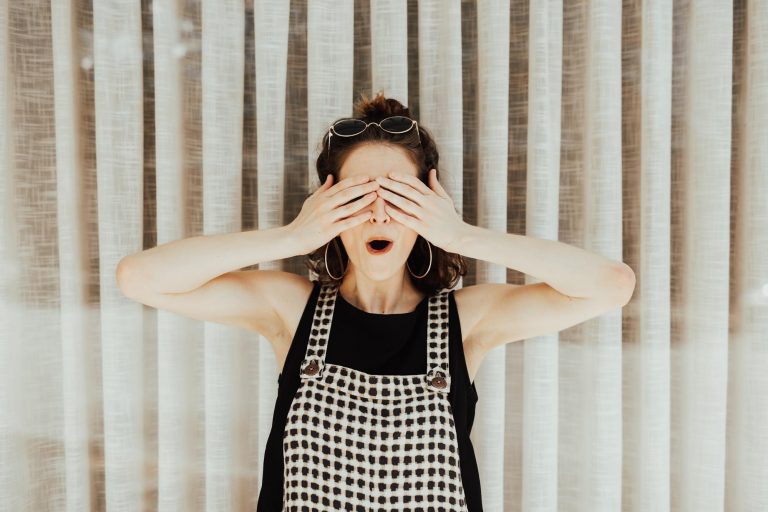 Woman covering her eyes with her hands